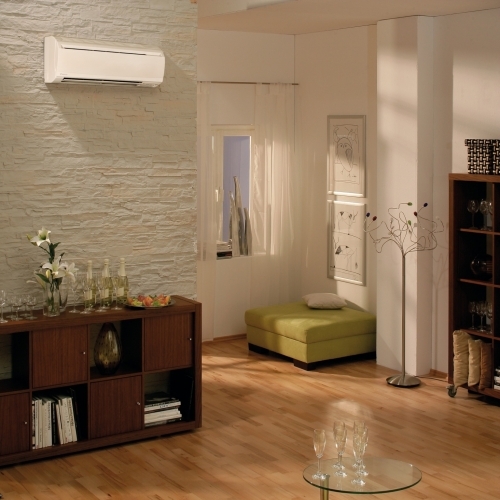 High Level Wall Mounted Air Conditioning Unit In A Residential Family Room